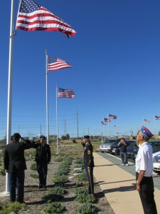 Former Staff Sgt. Frank M. Wada, far right, who served with the famous Japanese-American 442nd/100th Regimental Combat Team during World War II, salutes as soldiers raise an American flag in his honor at Miramar National Cemetery. 