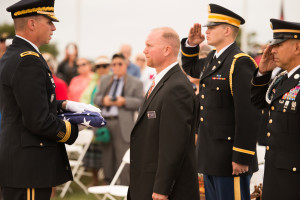Brig. Gen. Joseph Martin presents the ceremonial flag to Cemetery Director Douglas Ledbetter. The flag, a Medal of Honor, and a commemorative brass plaque will be displayed in the cemetery’s Administration Building.