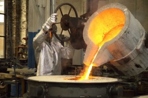 A Verdin Company foundry worker pours molten bronze into a mold to make a commemorative bell. After the metal cools overnight, the mold is broken and the new bell is removed, smoothed and prepared for final touches. 